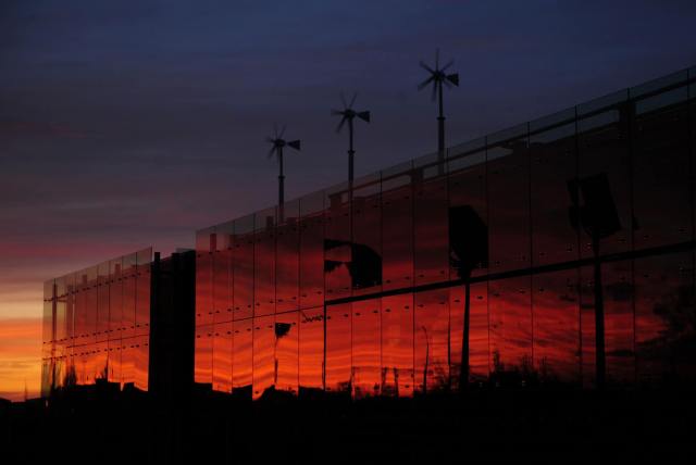 The LEED-platinum certified "5.4.7 Art Center" and its wind turbines stands at sunset, December 1, 2009, in Greensburg, Kansas