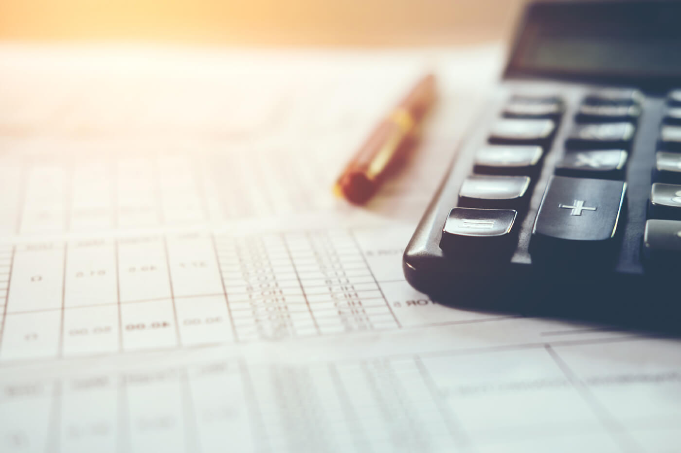 A calculator and pen to calculate federal tax credit