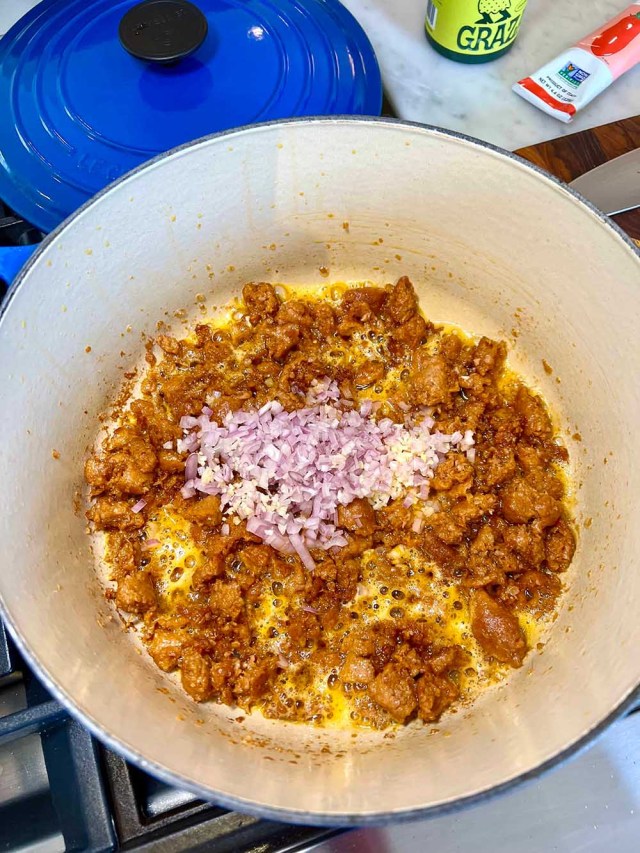 Beyond Sausage browning in olive oil (with shallot & garlic).