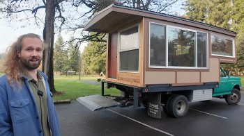 He was able to fit in a full-size bed along with all his kitchen necessities and even a wall storage area.